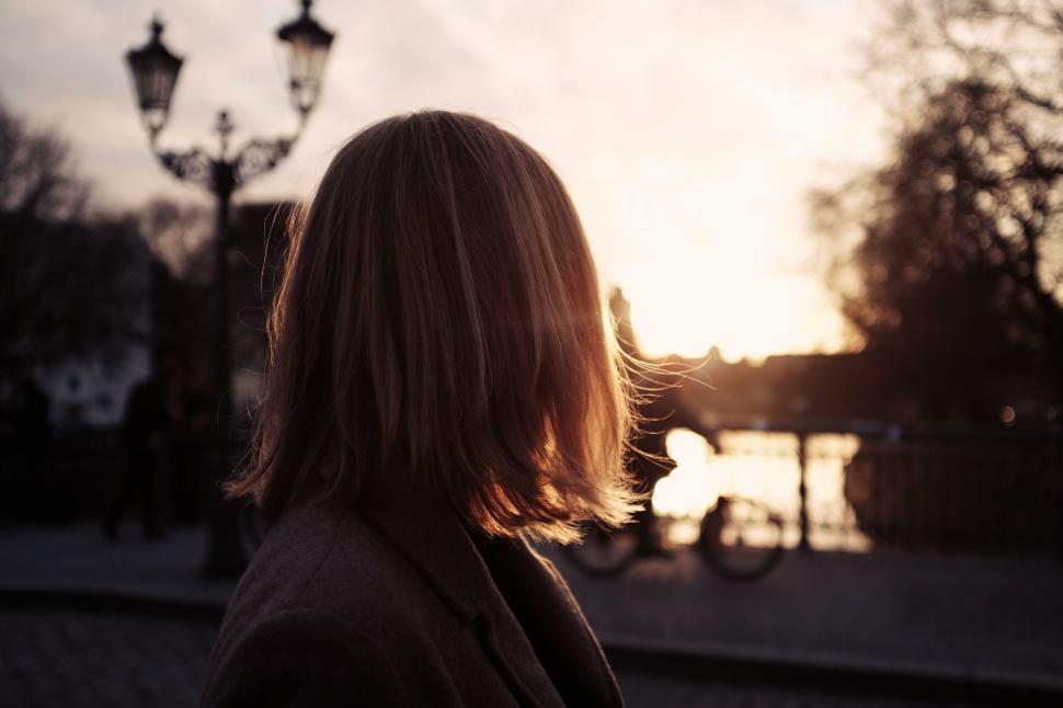 Free Image of Woman Standing in Front of Street Light 
