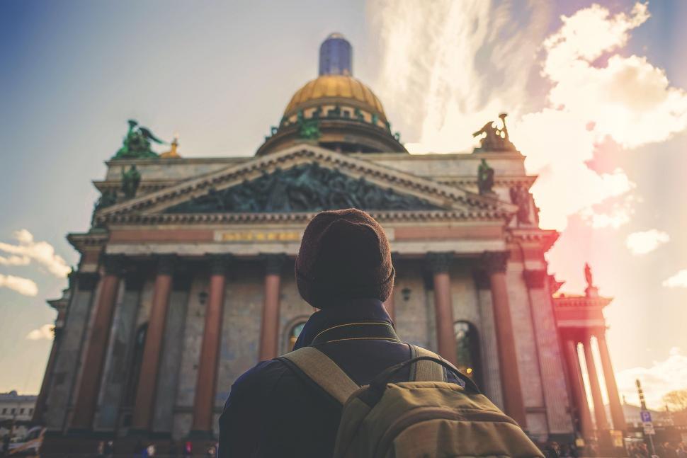 Free Image of Man With Backpack Standing in Front of Building 