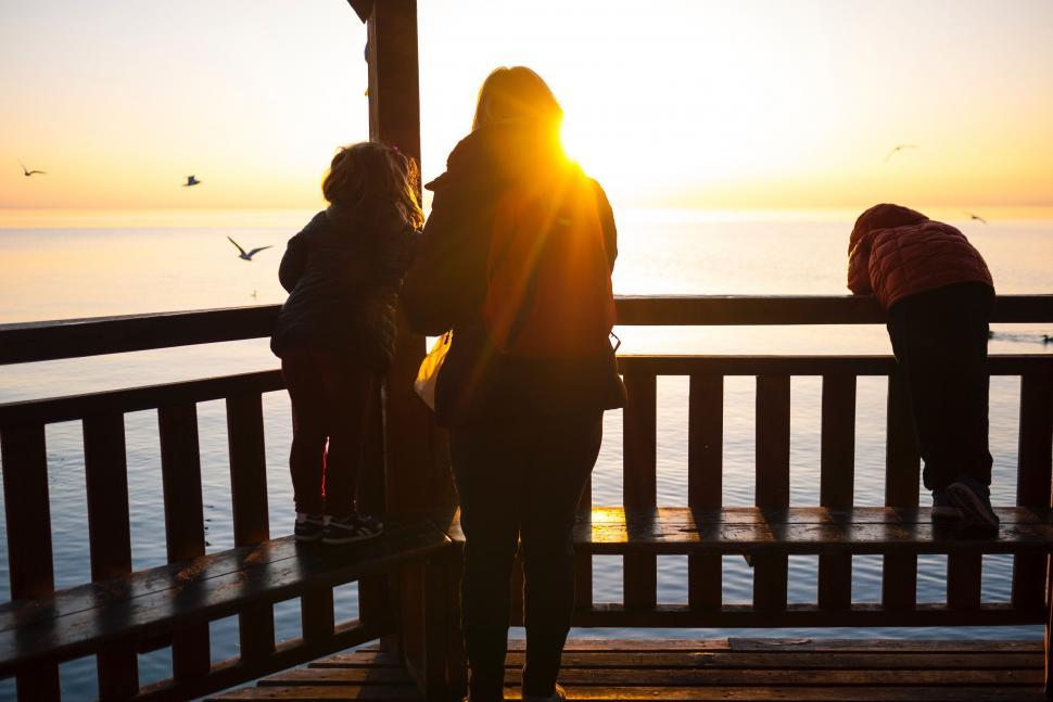 Free Image of Group of People Standing on Top of a Pier 