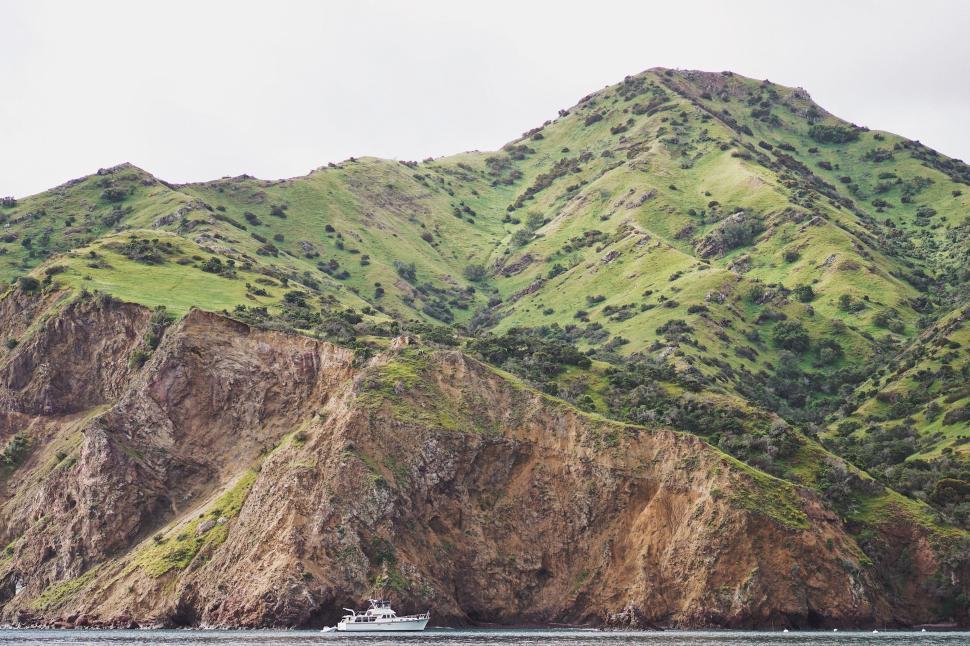 Free Image of Boat Crossing Lake Near Mountain 