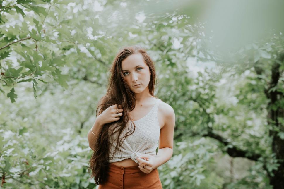 Free Image of Woman Standing in Front of Tree 