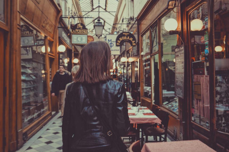 Free Image of Woman Walking Down Narrow Alleyway 