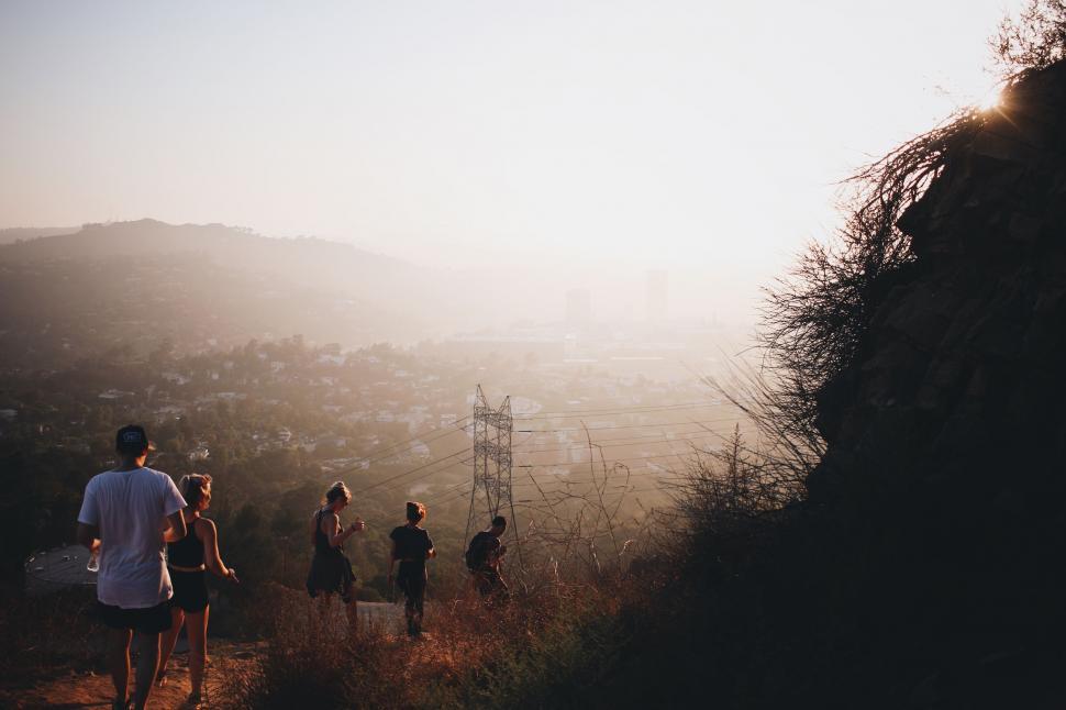 Free Image of Group of People Standing on Top of a Hill 