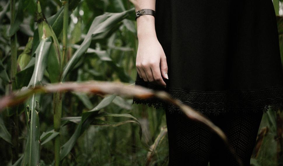 Free Image of Woman Standing in Field of Tall Grass 