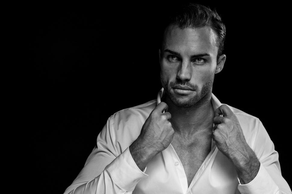 Free Image of Man in White Shirt Holding a Cigarette 