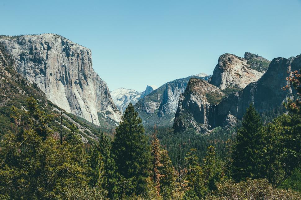 Free Image of Majestic Mountain Range With Foreground Trees 