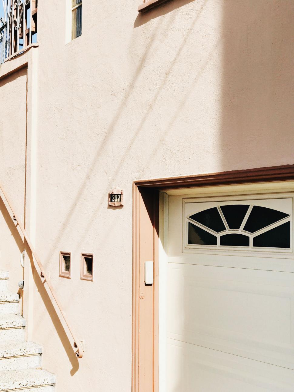 Free Image of Cat Sitting on Steps of Building 