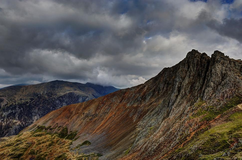 Free Image of Majestic Mountain Towering Under Cloudy Sky 