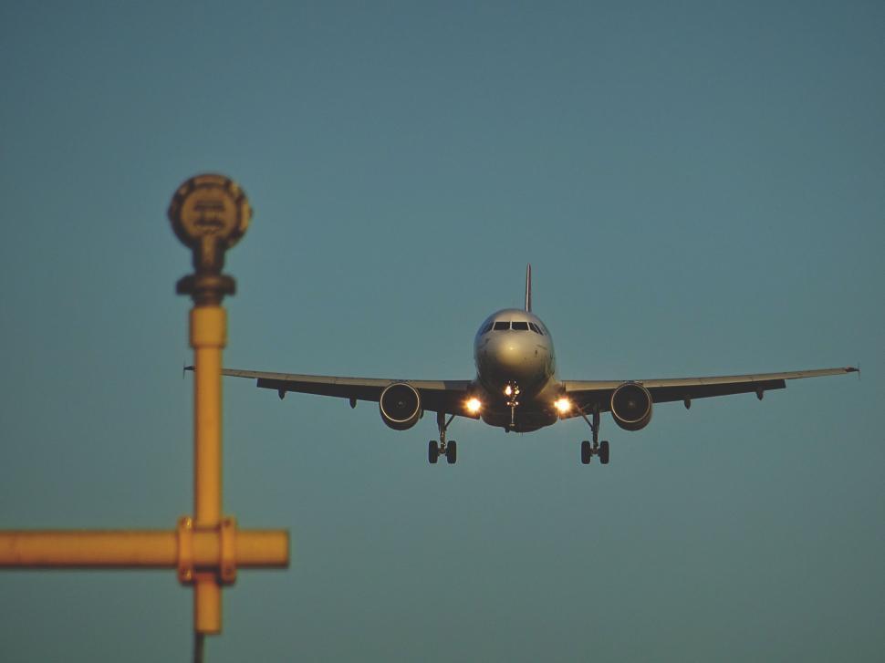 Free Image of Large Jetliner Flying Through Blue Sky 