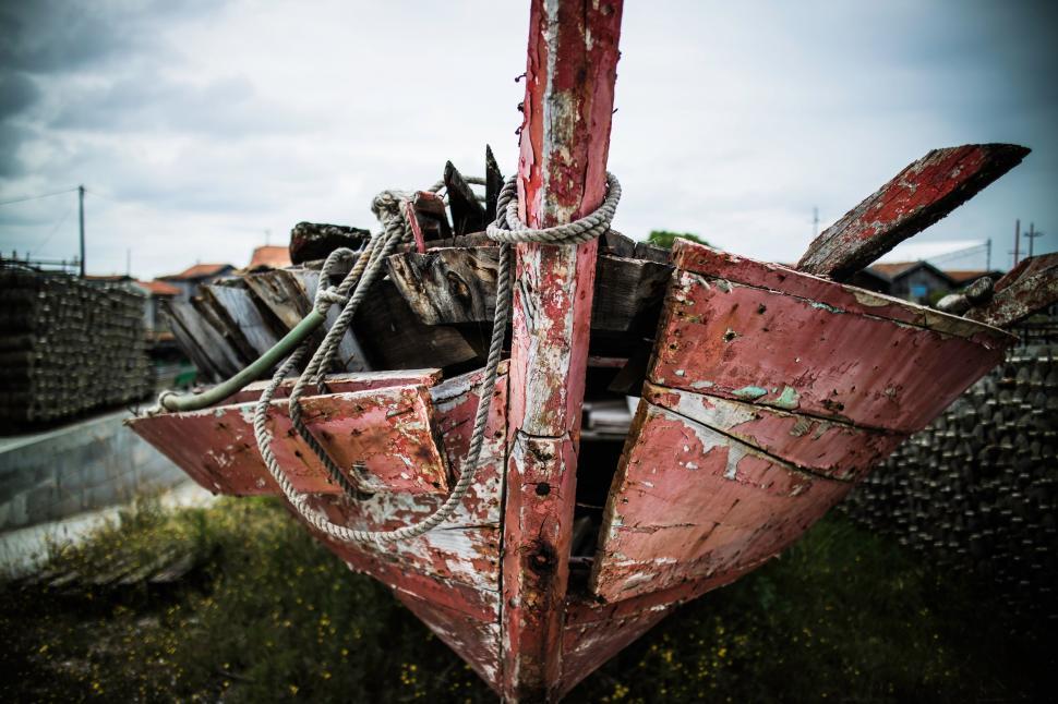 Free Image of Red Boat on Lush Green Field 