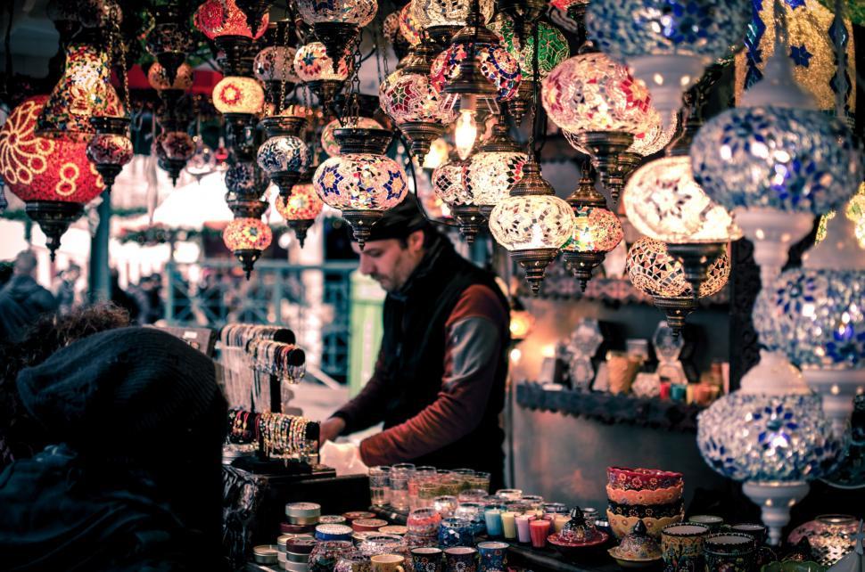 Free Image of Man Standing in Front of Store With Lots of Lights 