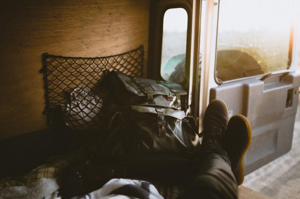 Free Image of Person Laying on Bed Next to Window 