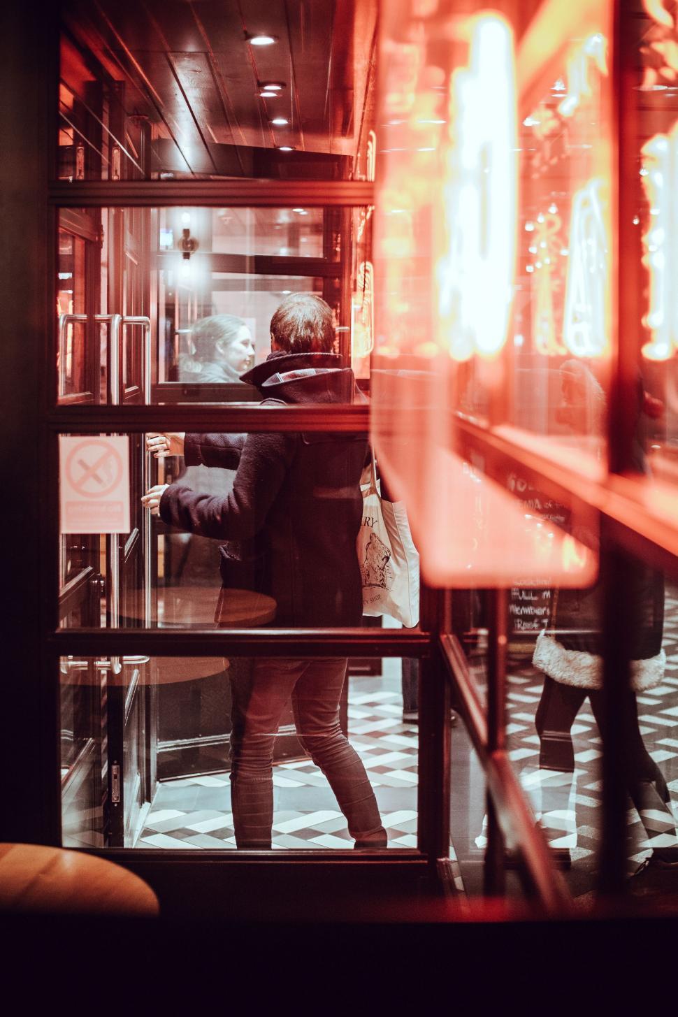Free Image of Man Standing in Front of Display Case 