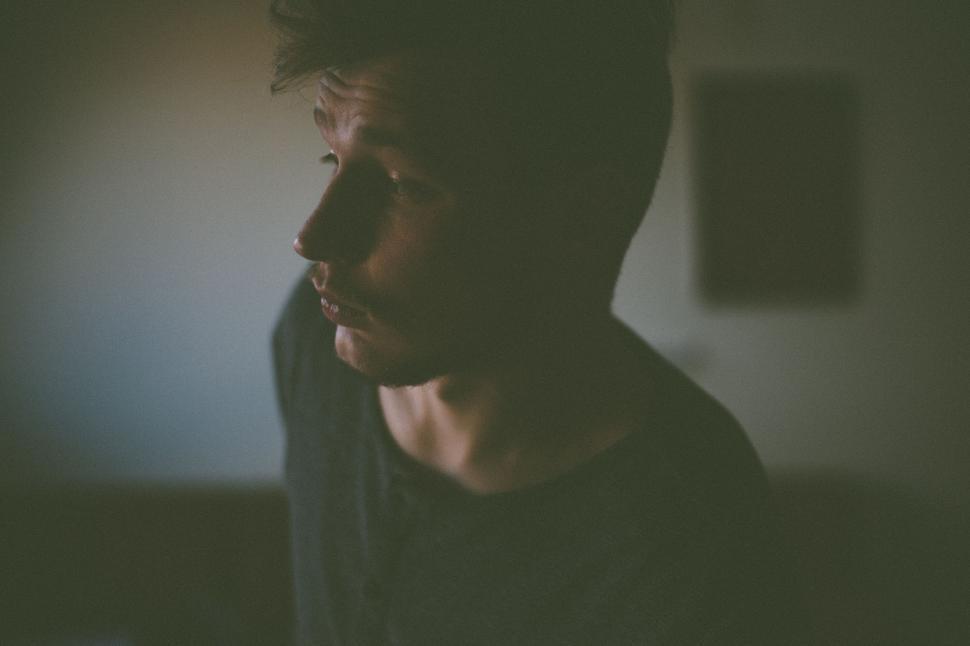 Free Image of Man Speaking on Cell Phone in Dark Room 