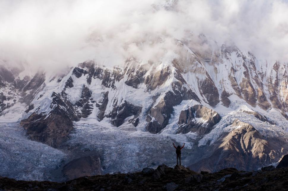 Free Image of Man Standing on Top of Snow Covered Mountain 