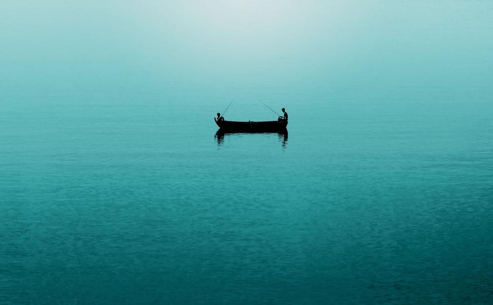 Free Image of Small Boat Floating on Large Body of Water 