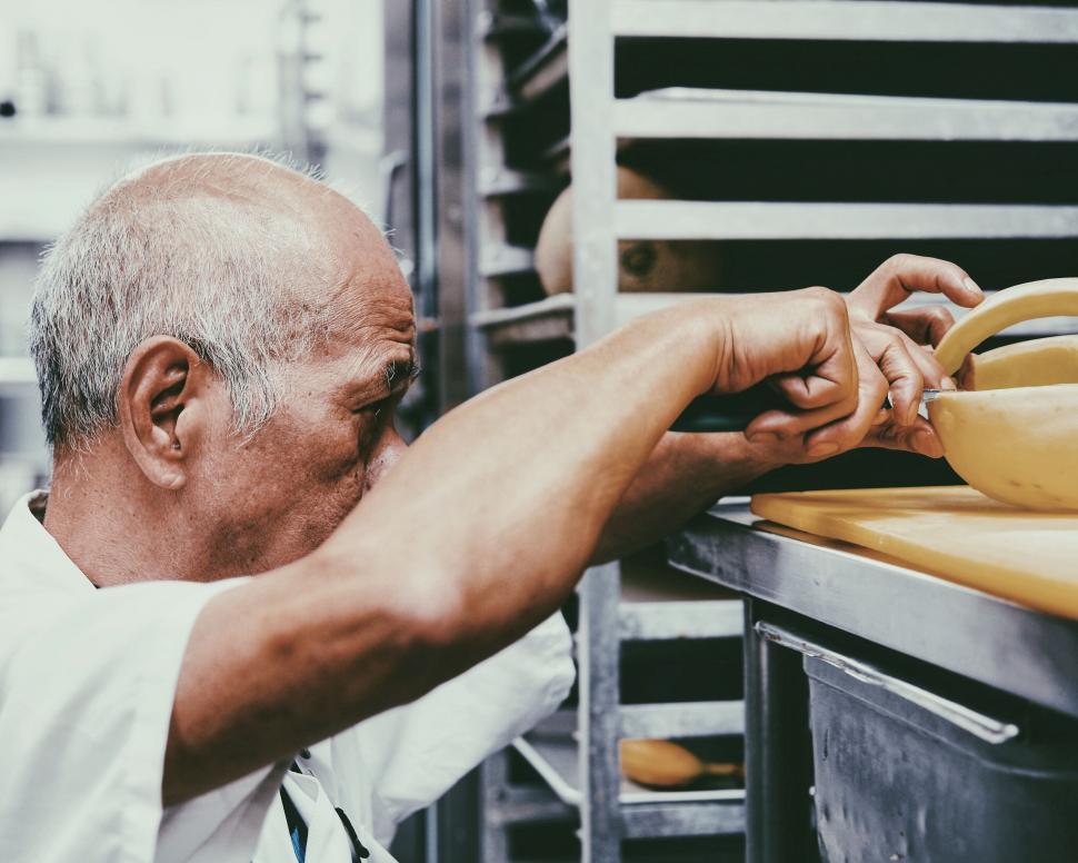 Free Image of Man Putting Something in the Oven 