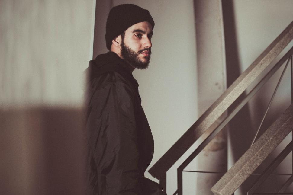 Free Image of Man Standing Next to Staircase 
