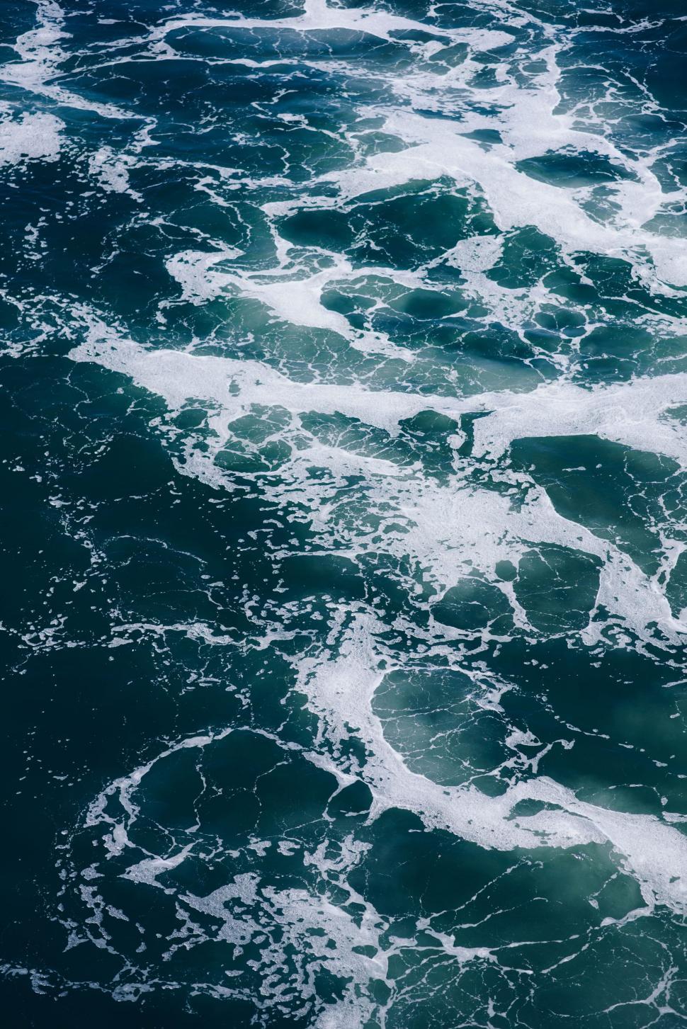 Free Image of Large Body of Water Covered in White Foam 