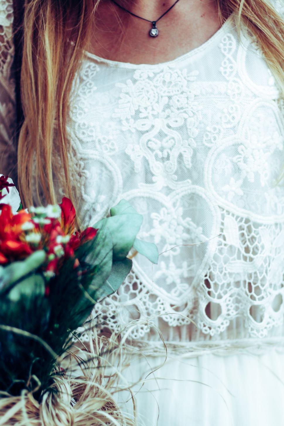 Free Image of Woman Holding a Bouquet of Flowers 