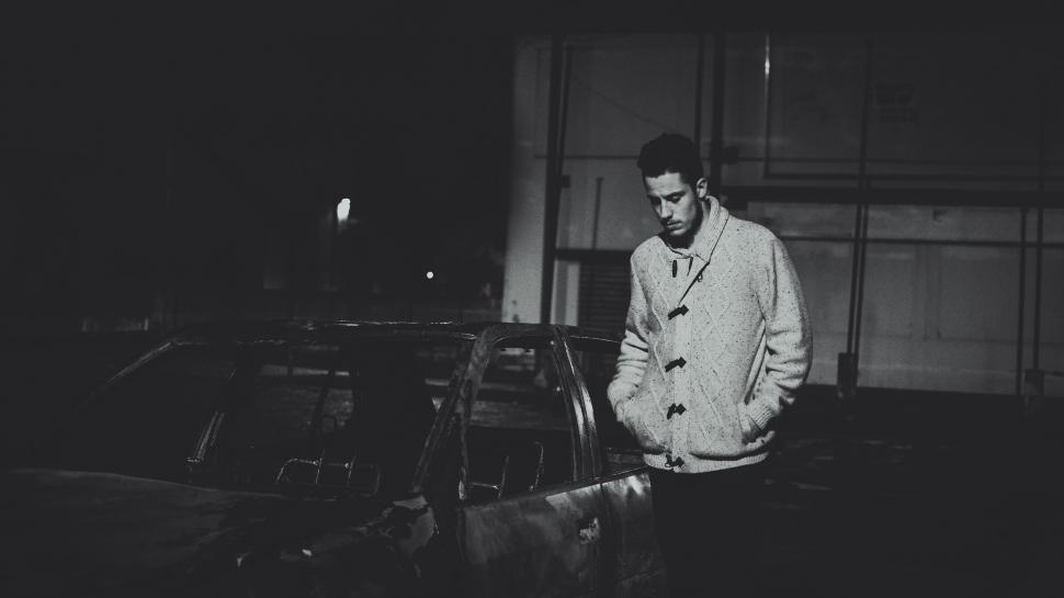 Free Image of Man Standing Next to Car in the Dark 