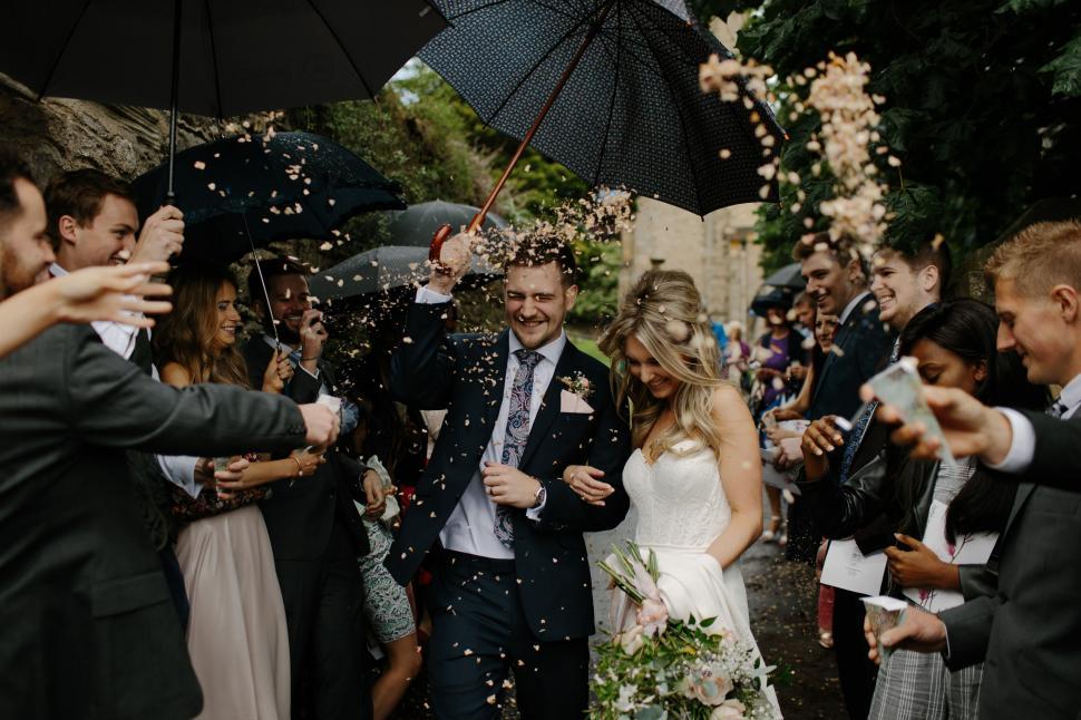 Free Image of Group of People Standing Under an Umbrella 