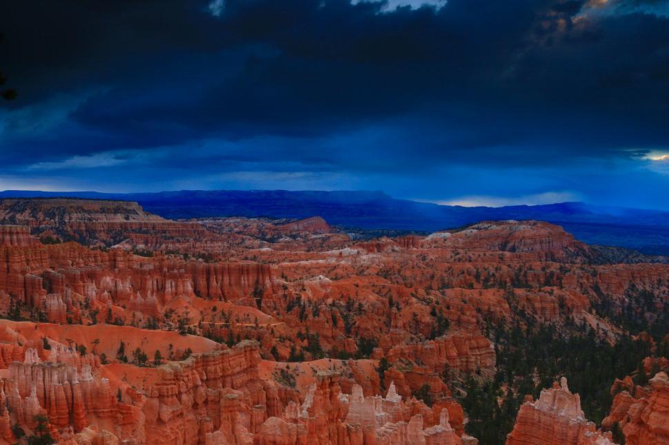 Free Image of Dark Clouds Looming Over Mountain Range 