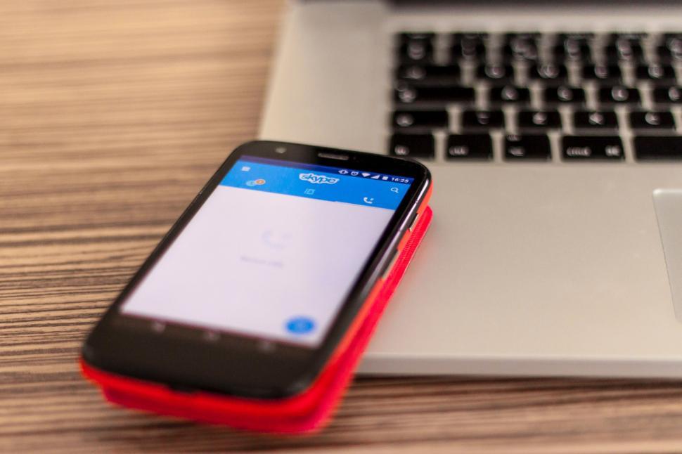 Free Image of Cell Phone Next to Laptop Computer 