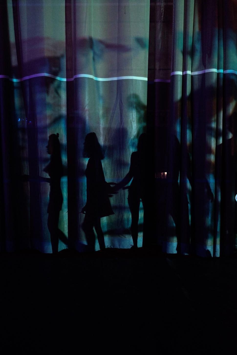 Free Image of Group of People Standing in Front of Window 