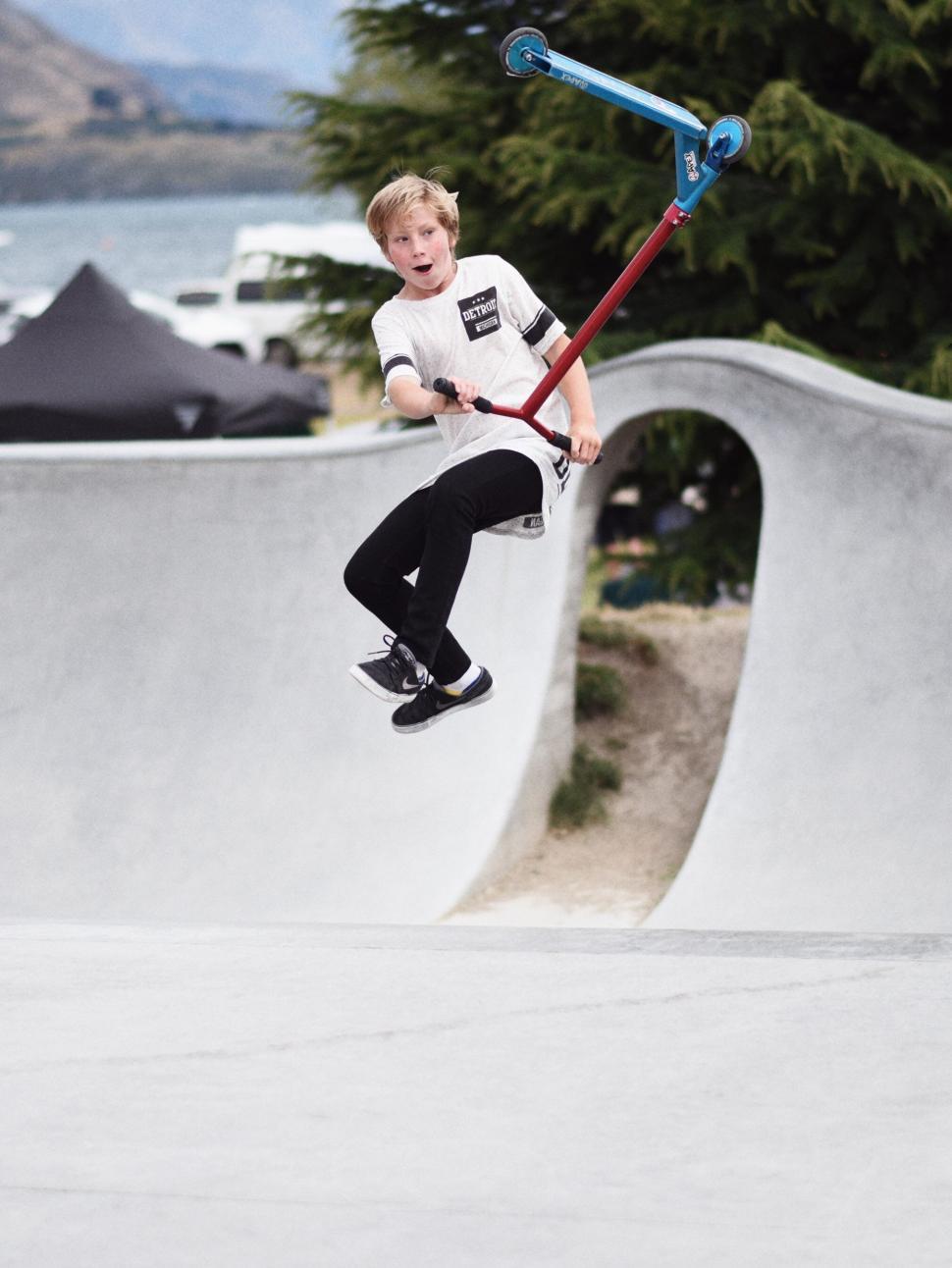 Free Image of Young Boy Skateboarding Trick 
