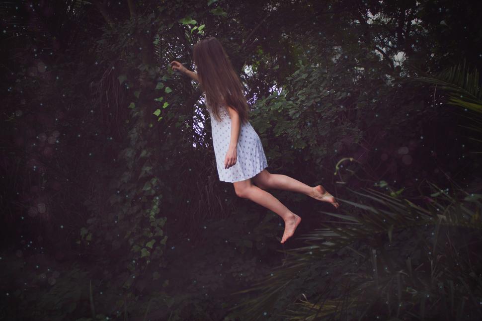 Free Image of Woman in White Dress Flying Through the Air 