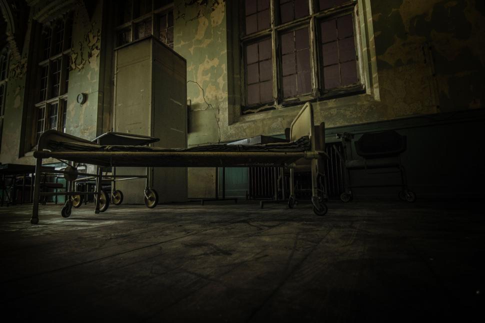 Free Image of Dark Room With Bed and Bicycle 
