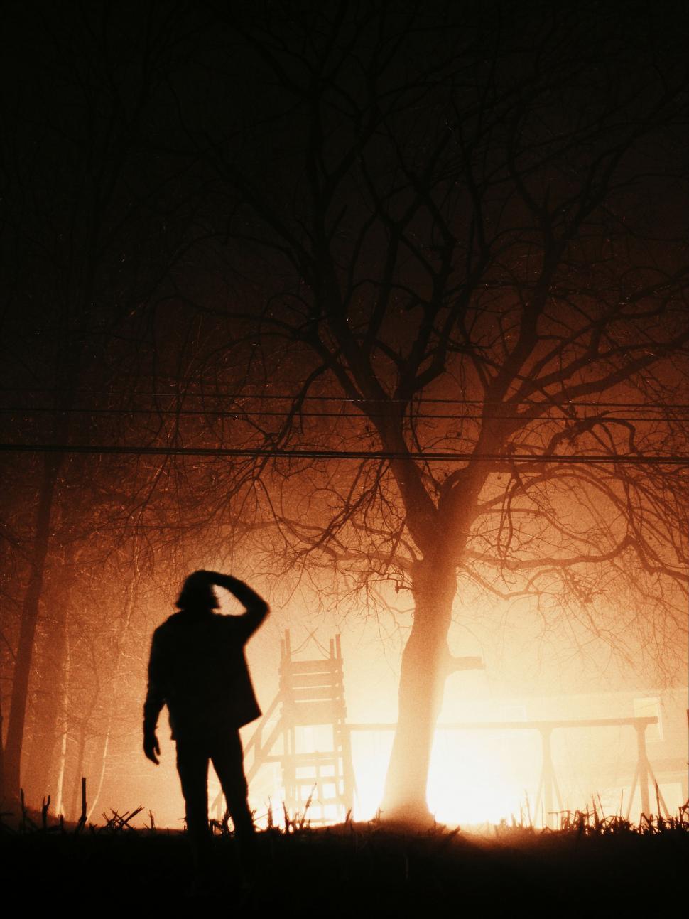 Free Image of Person Standing in Front of Fire 