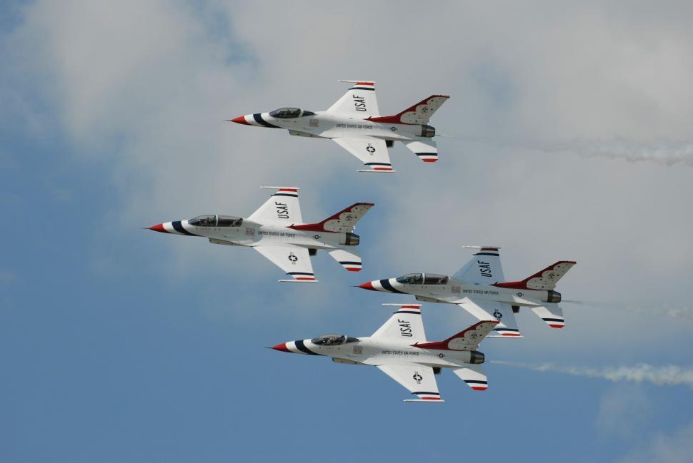Free Image of Group of Fighter Jets Flying Through Cloudy Sky 