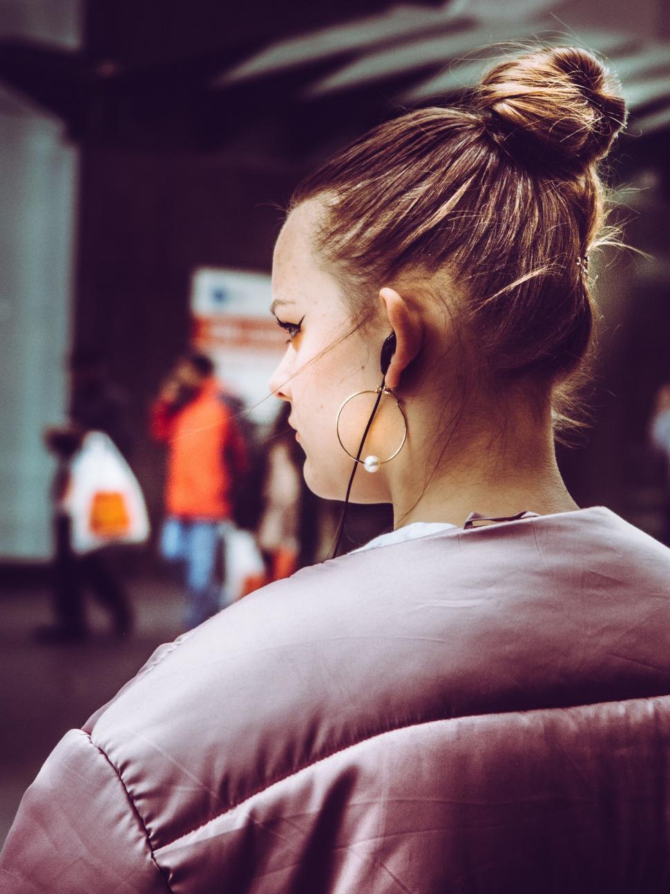 Free Image of Woman in Brown Jacket Looking at Cell Phone 