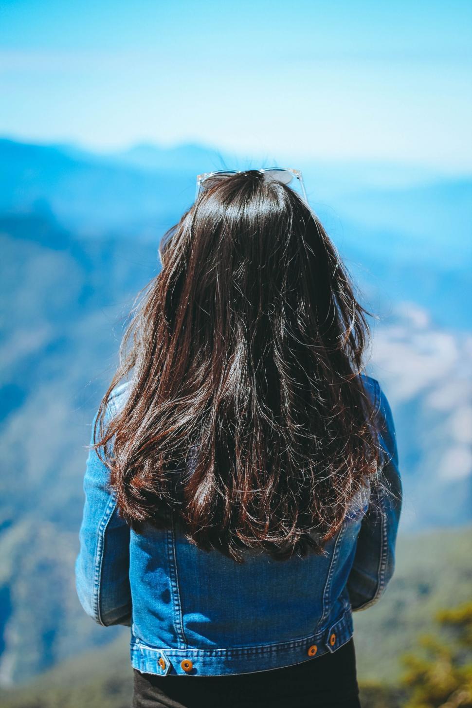 Free Image of Woman Standing on Mountain Summit 