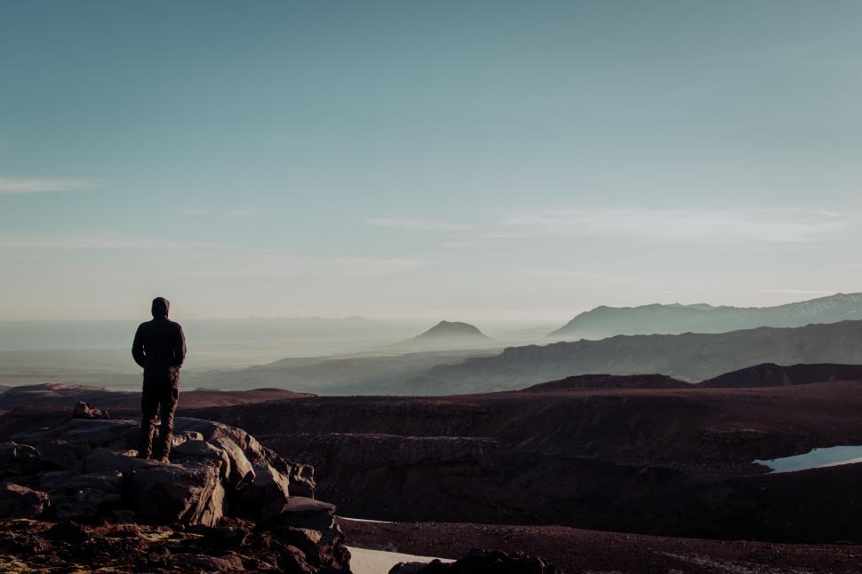 Free Image of Man Standing on Top of Rocky Hillside 
