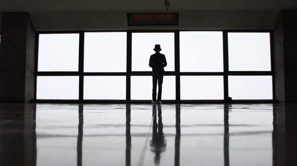 Free Image of Person Standing in Front of Large Window 