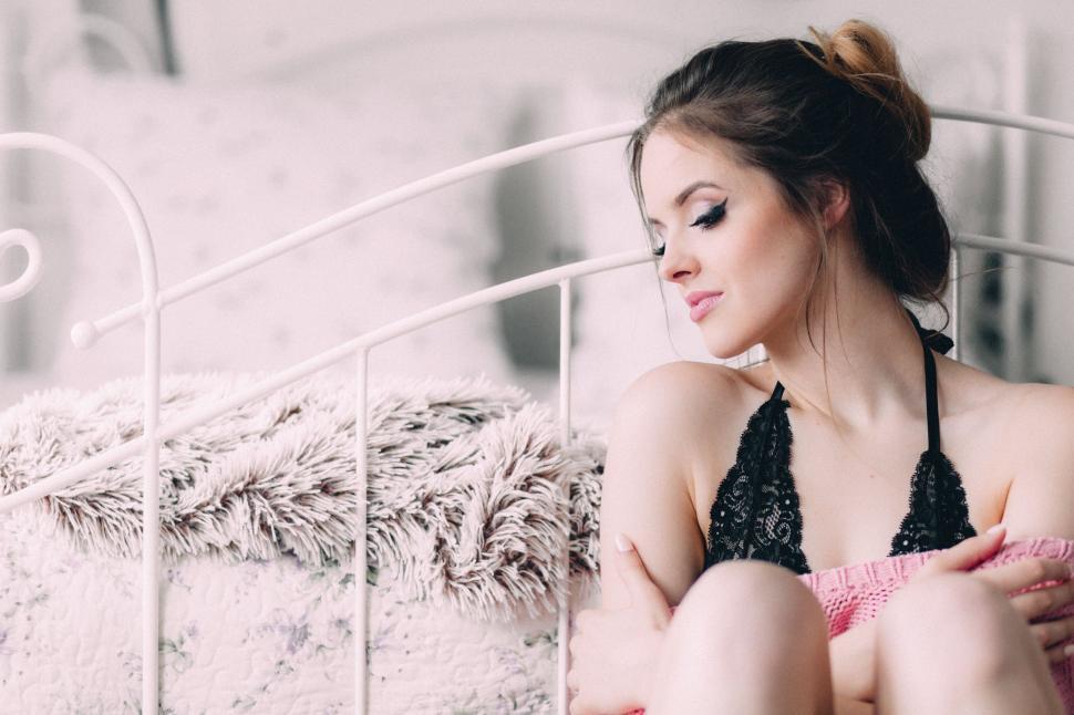 Free Image of Woman in Bikini Sitting on Bed 