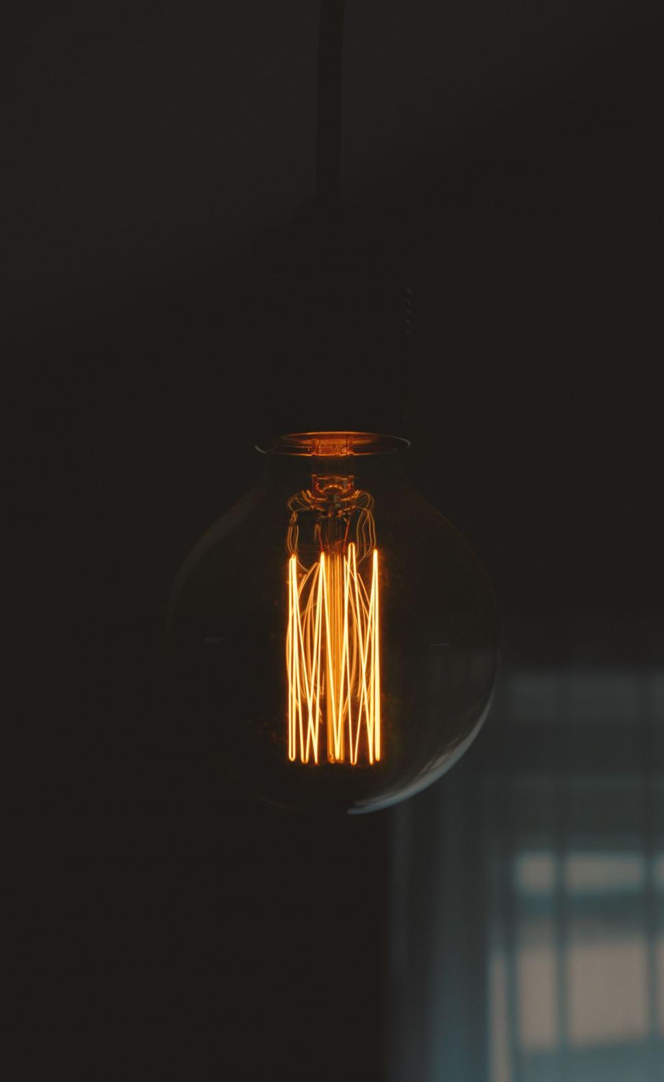 Free Image of Bright Illuminated Light Bulb in Darkness 