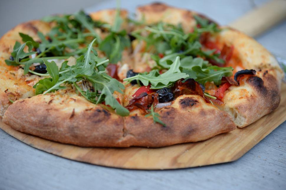 Free Image of Close Up of Pizza on Cutting Board 
