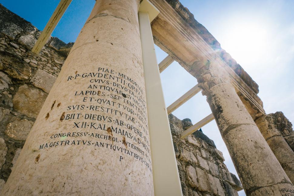 Free Image of Tall Column With Writing Against Blue Sky 