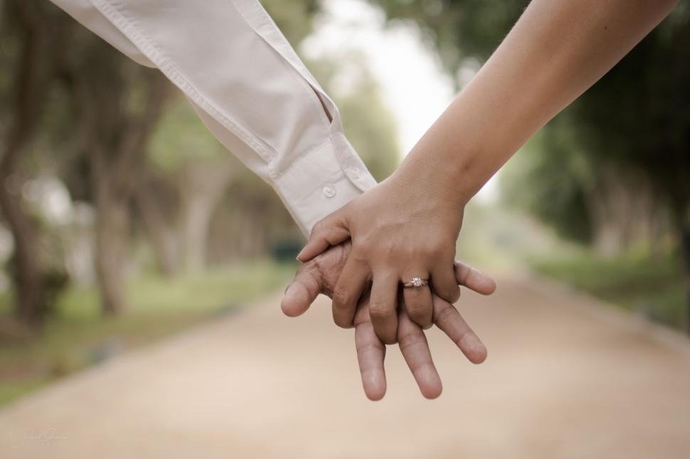 Free Image of Close Up of Two People Holding Hands 