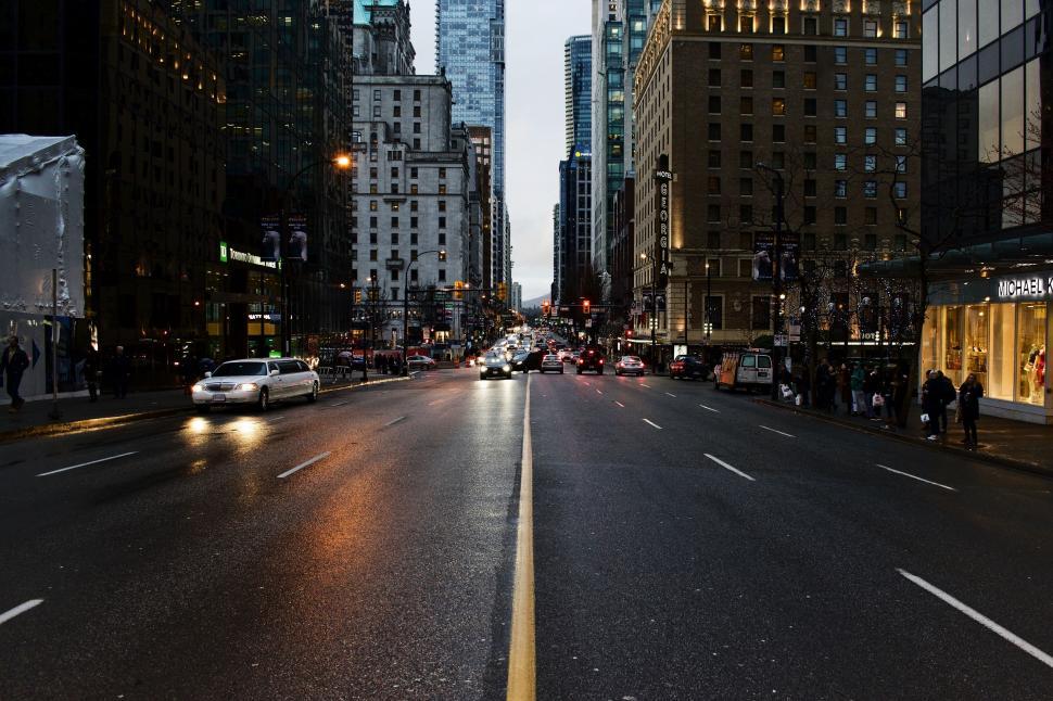 Free Image of Urban City Street With Tall Buildings and Cars 