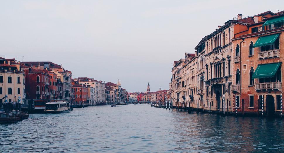 Free Image of River Flowing Through City Next to Tall Buildings 