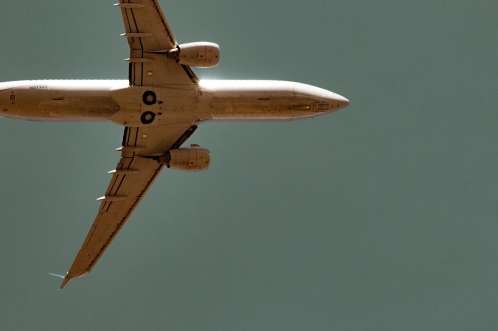 Free Image of Large Jetliner Flying Through Blue Sky 