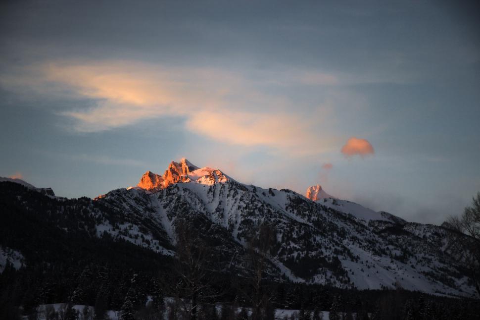 Free Image of Snow Covered Mountain With Clouds in the Sky 