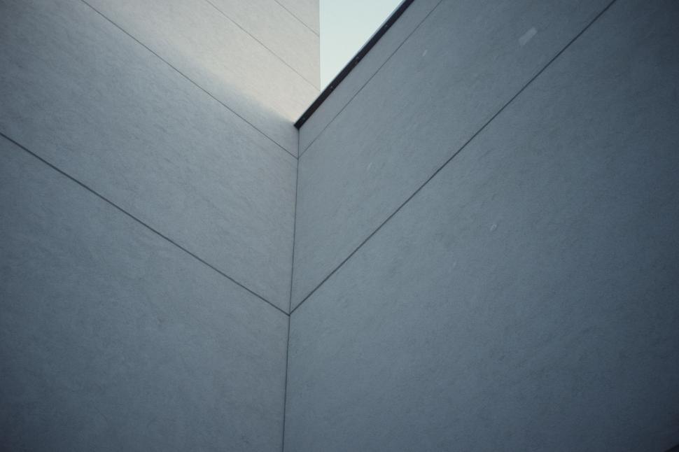 Free Image of The Corner of a Building Against a Sky Background 