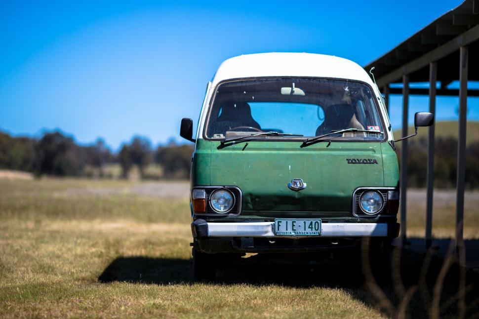 Free Image of Green and White Truck Parked in Field 