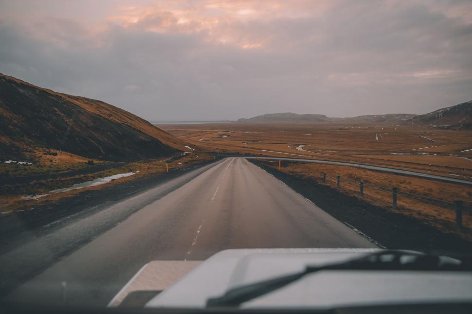 Free Image of Car Driving Down Desert Road 